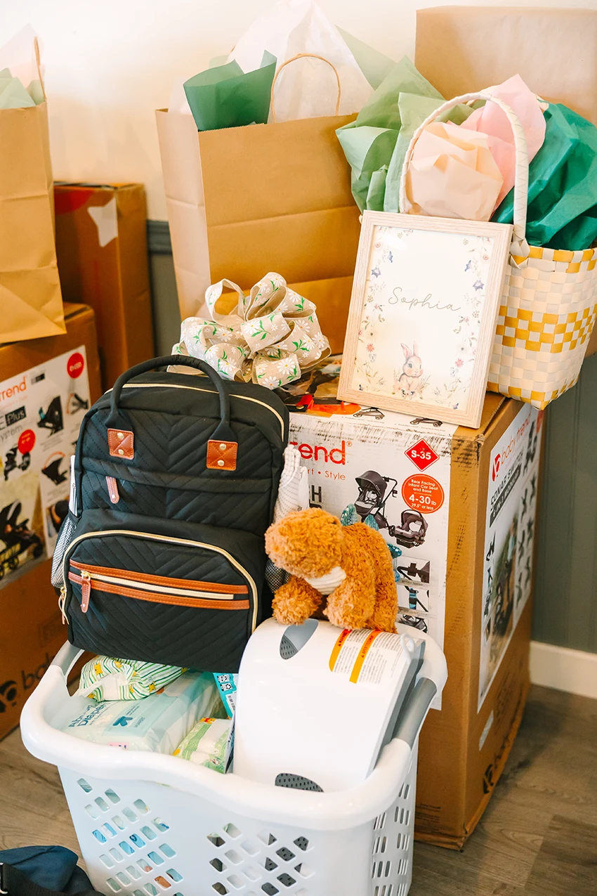 A stack of items that are given to expecting parents at a WeFoster LA baby shower event.